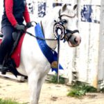 Child Dylan Ward riding white pony Bone Cancer ambassador